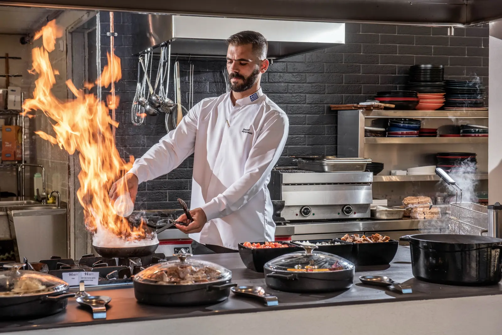 Chef flambéing at a live cooking station