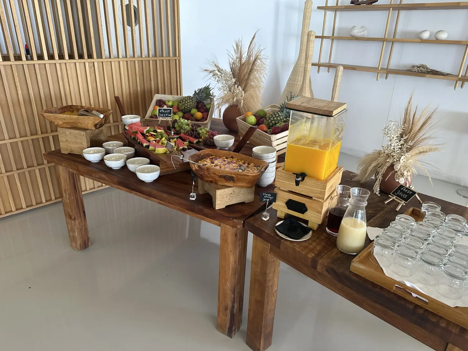 Fruit and juice station with wooden crates and a juice dispenser