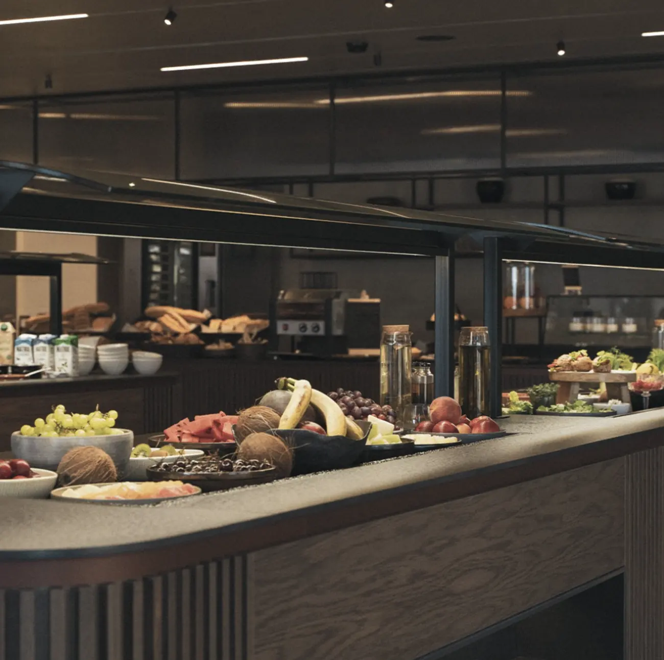 Fruit and coconuts on a dark fluted buffet counter