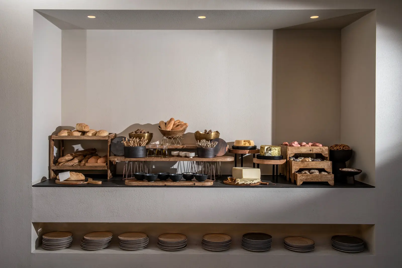 Bread and cheese buffet in a lit wall niche